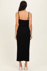 woman wearing a black ribbed maxi dress with thin straps, viewed from the back