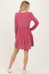 woman wearing a burgundy ribbed long sleeve dress with a tiered skirt and a relaxed fit, viewed from the back