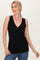 woman wearing a black sleeveless wrap top with a deep v-neck and gathered detail, styled with blue jeans