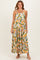 woman wearing a colorful floral print maxi dress with adjustable straps and a tiered design