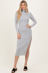 woman wearing a gray ribbed turtleneck midi dress with a side slit and long sleeves