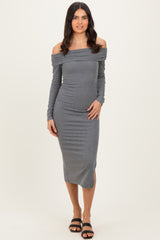 woman wearing a gray off-the-shoulder midi dress with long sleeves and side slits