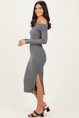 woman wearing a grey off-the-shoulder midi dress with a side slit and long sleeves