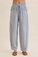 woman wearing blue and white striped loose-fitting pants with an elastic waistband and side pockets