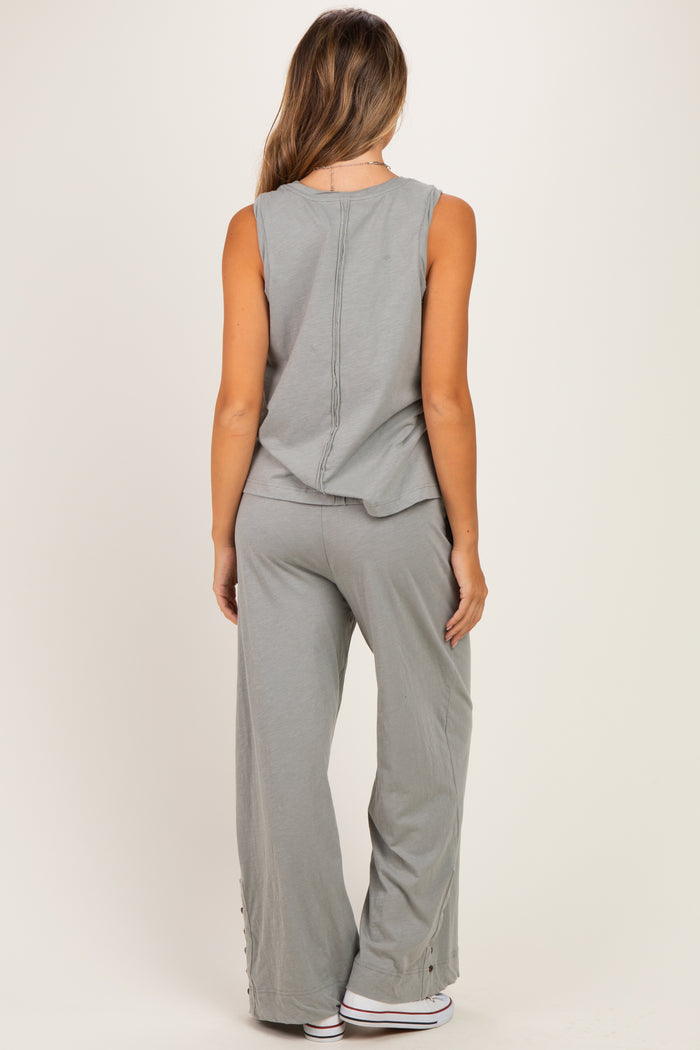 woman wearing a relaxed fit gray maternity tank top and coordinating wide-leg pants with side button details
