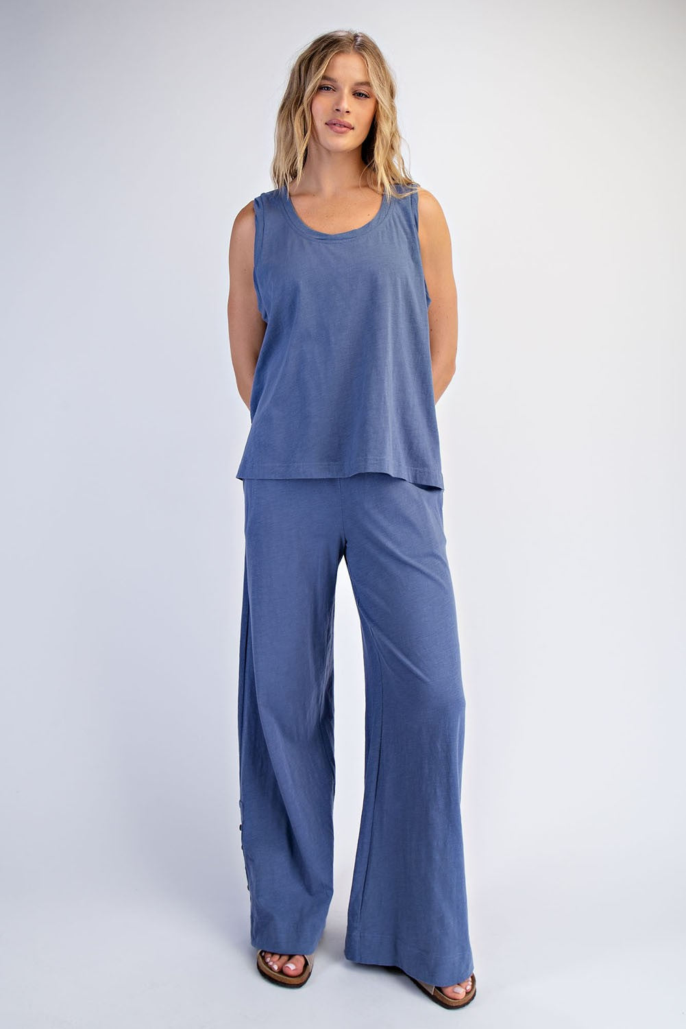 woman wearing a blue sleeveless top and matching wide-leg pants