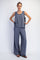 woman wearing a gray sleeveless top and loose-fitting gray wide-leg pants