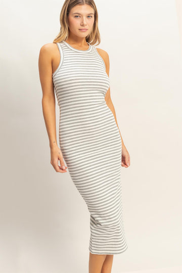 woman wearing a fitted gray and white striped ribbed midi dress with a sleeveless design