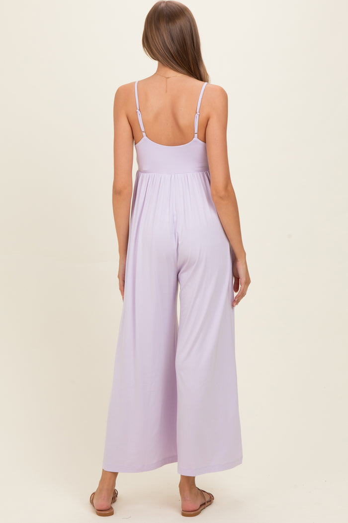 woman wearing a lavender maternity jumpsuit with wide legs and adjustable spaghetti straps, showing a baby bump