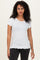 woman wearing a white short sleeve top with scalloped edges and a fitted style