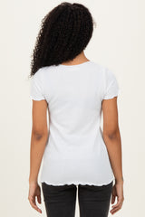 woman wearing a white short sleeve ribbed top with scalloped edges, viewed from the back
