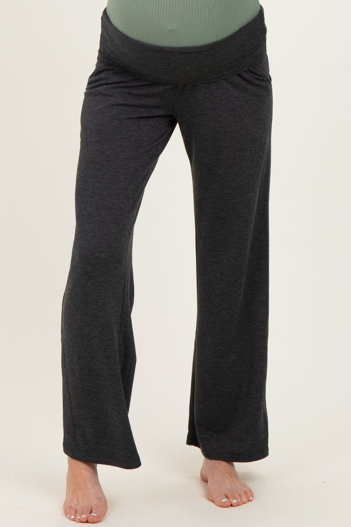 woman wearing black maternity lounge pants with a wide waistband and relaxed fit