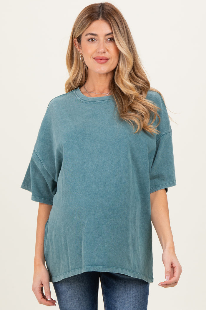 woman wearing a teal oversized maternity t-shirt with short sleeves and a relaxed fit