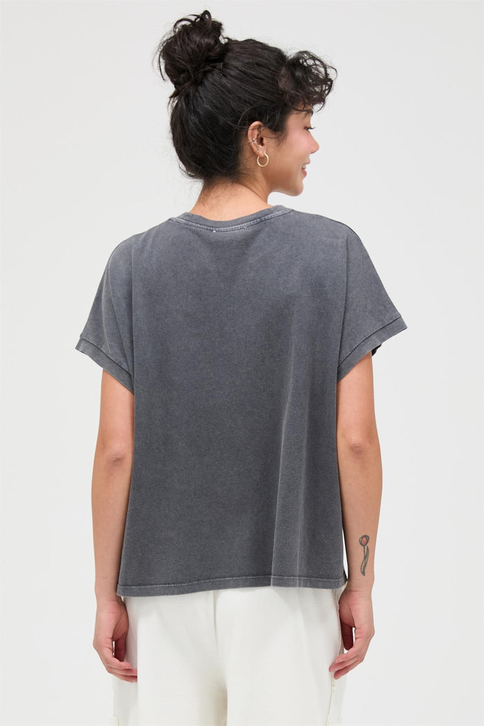 woman wearing a relaxed fit gray oversized t-shirt with short sleeves and a round neckline