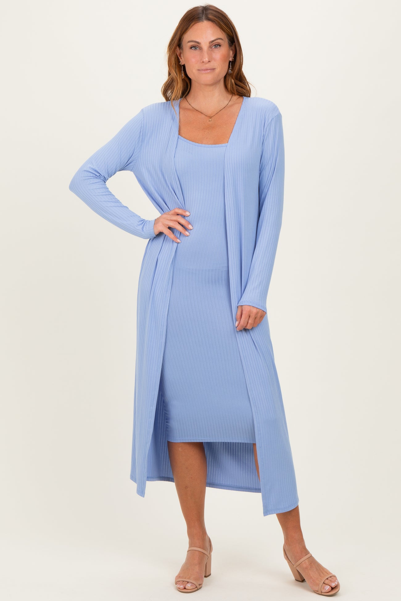 woman wearing a light blue ribbed long cardigan over a matching midi dress with a square neckline