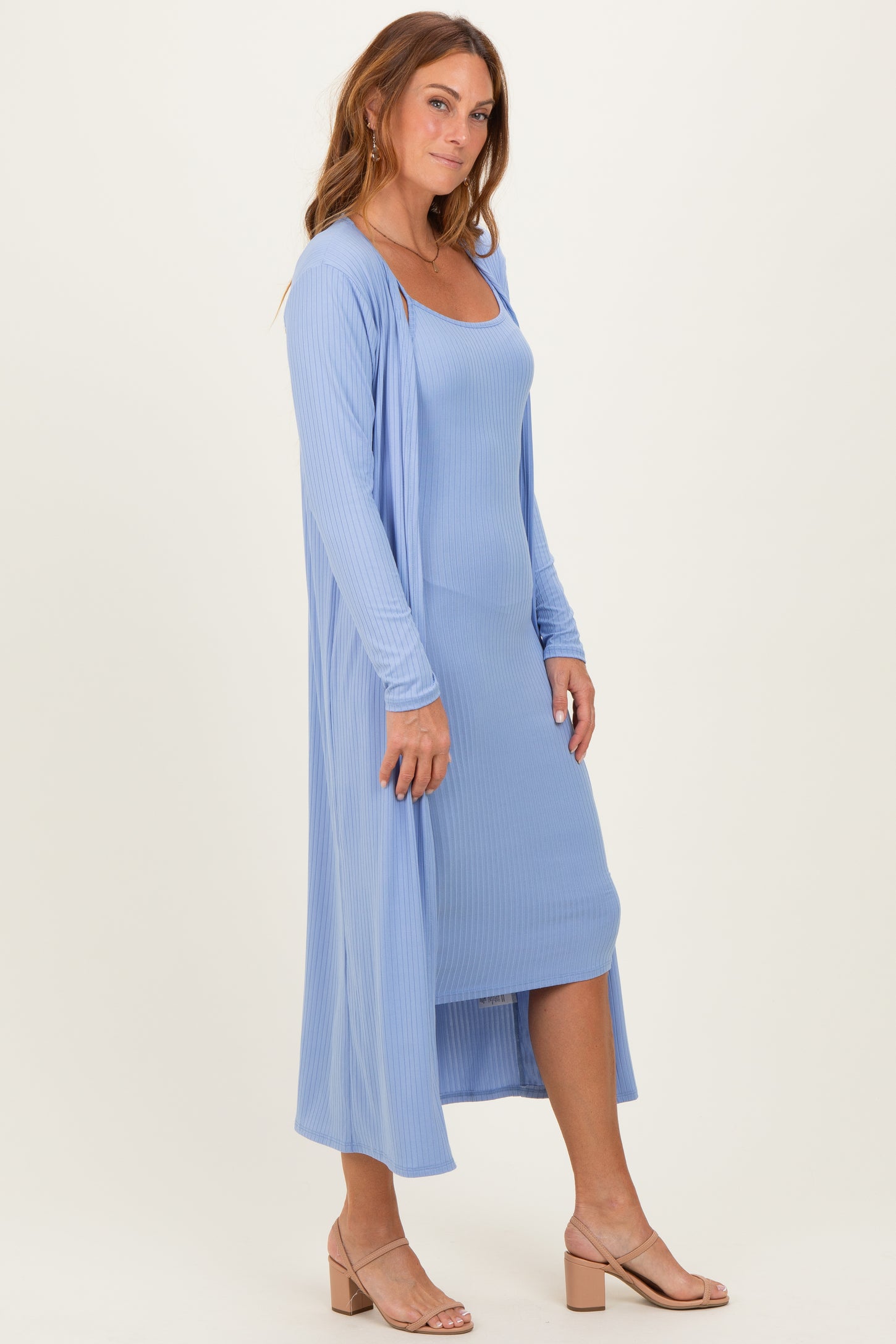 woman wearing a light blue ribbed maxi dress with a matching duster cardigan and beige heeled sandals