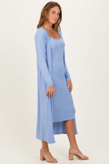 woman wearing a light blue ribbed maxi dress with a matching duster cardigan and beige heeled sandals