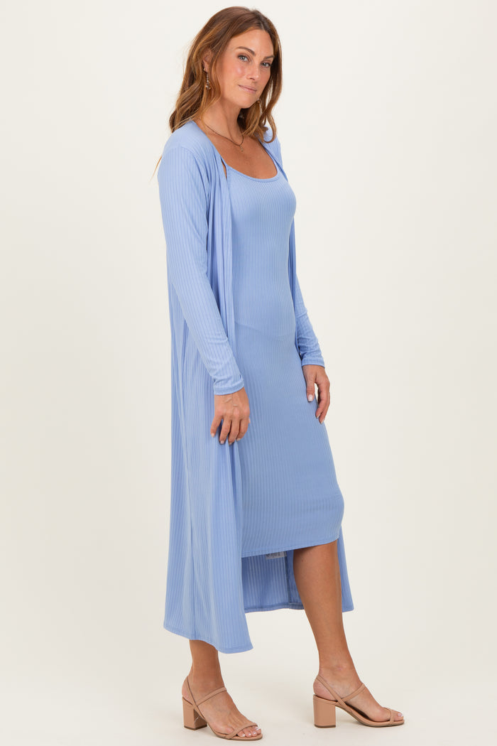 woman wearing a light blue ribbed maxi dress with a matching duster cardigan and beige heeled sandals