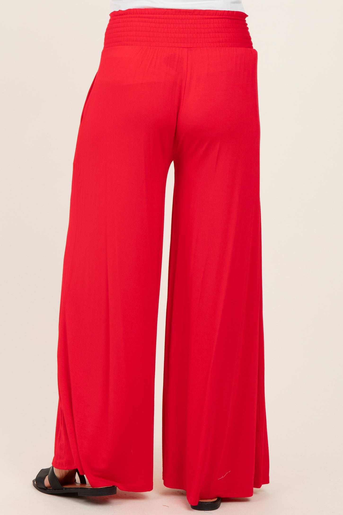 red wide-leg maternity pants with a stretchy waistband, viewed from the back
