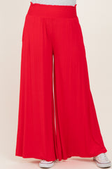 woman wearing red wide-leg pants with a smocked waistband and relaxed fit