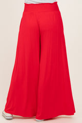 woman wearing red wide-leg pants with a smocked waistband, viewed from the back