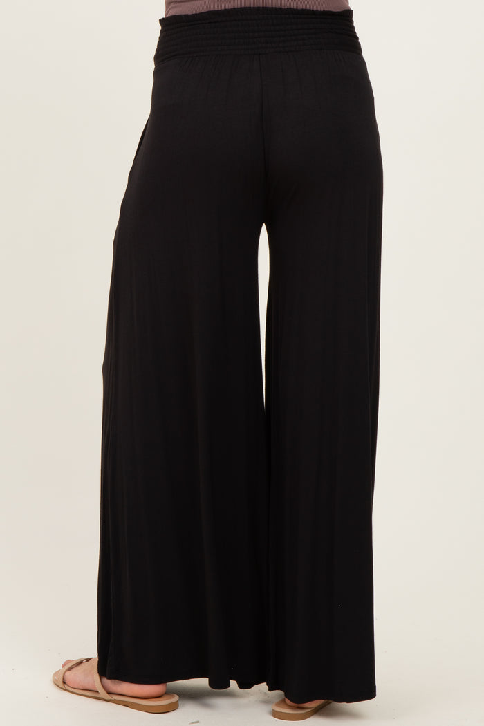 woman wearing black maternity wide-leg pants viewed from the back
