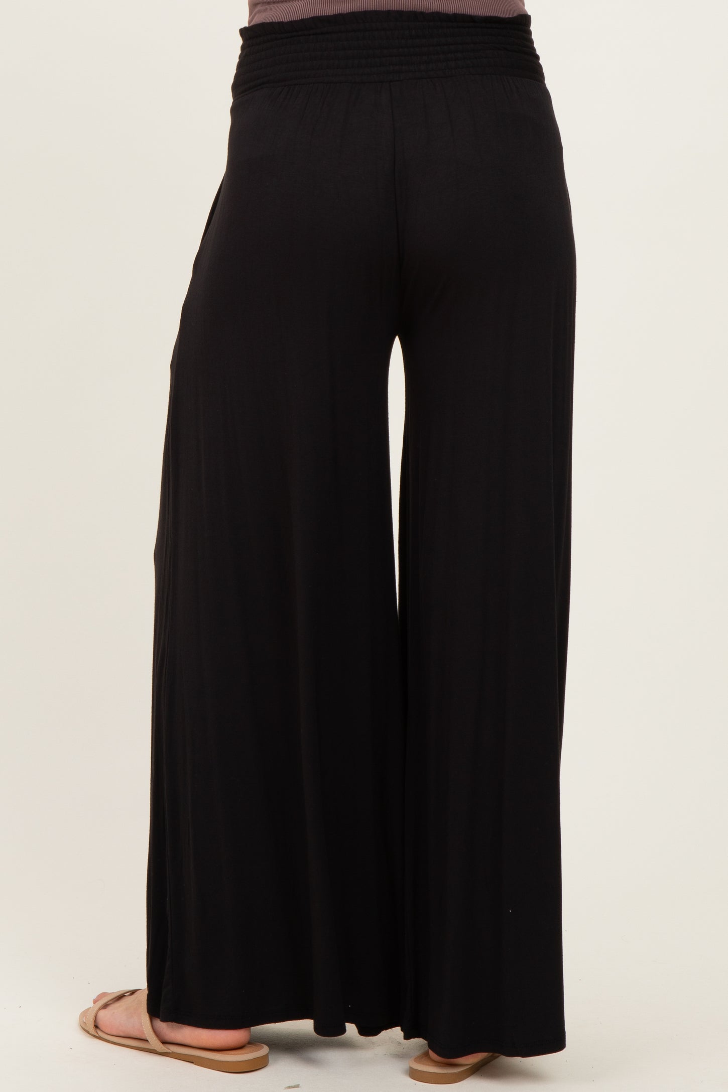 woman wearing black maternity wide-leg pants viewed from the back