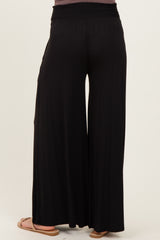 woman wearing black maternity wide-leg pants viewed from the back