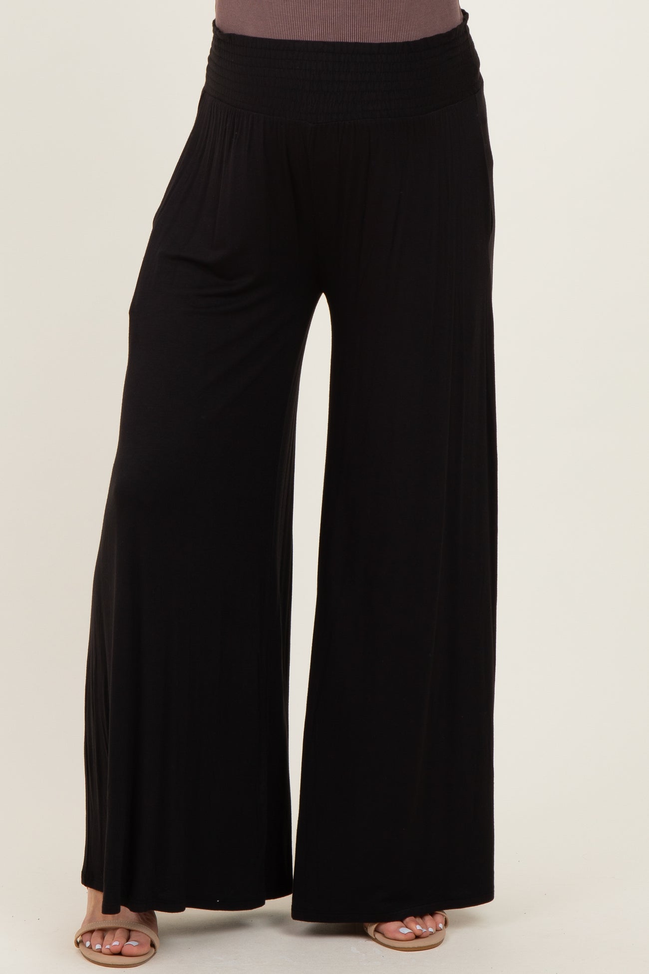 maternity wear black wide-leg pants with a smocked waistband, model not visible.