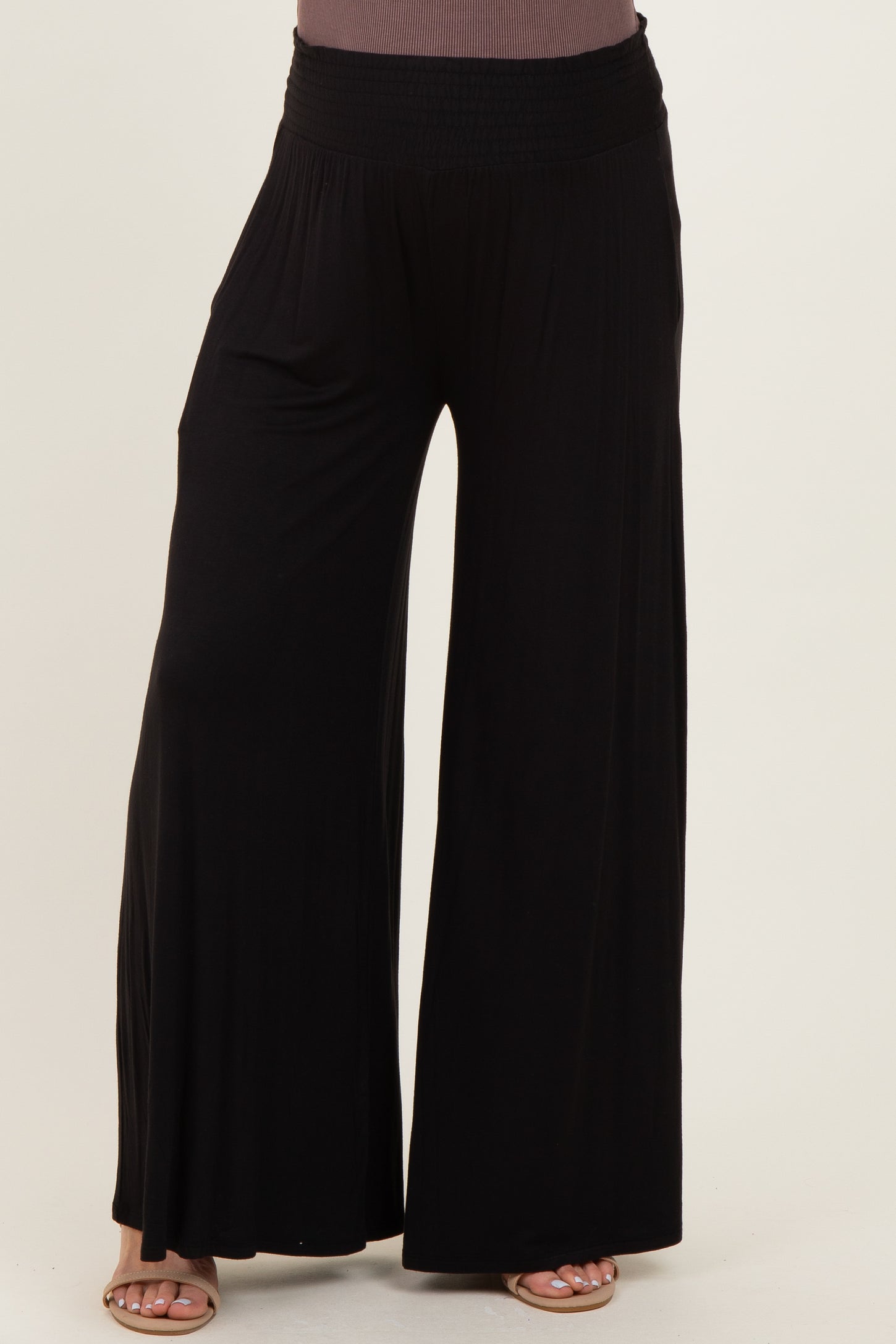 maternity wear black wide-leg pants with a smocked waistband, model not visible.