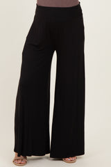 maternity wear black wide-leg pants with a smocked waistband, model not visible.