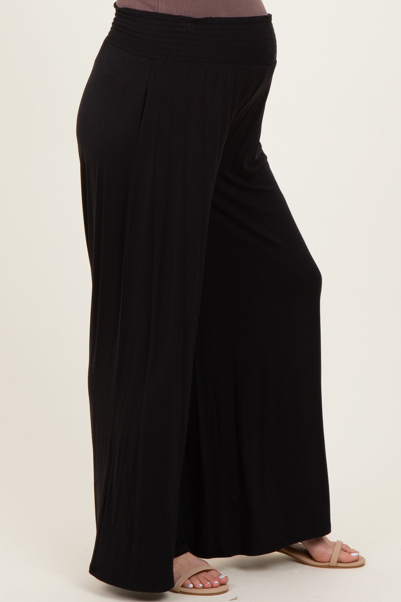 woman wearing black maternity wide-leg pants with a comfortable elastic waistband and a relaxed fit