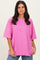 woman wearing an oversized hot pink t-shirt with short sleeves and a relaxed fit