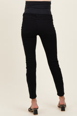 woman wearing black maternity skinny jeans with a high waistband and a fitted silhouette, showing the back view