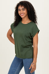 woman wearing a green short sleeve relaxed fit t-shirt paired with blue jeans