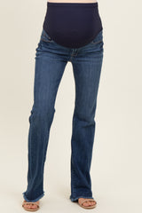 woman wearing dark blue maternity jeans with a stretchy waistband and frayed hem details