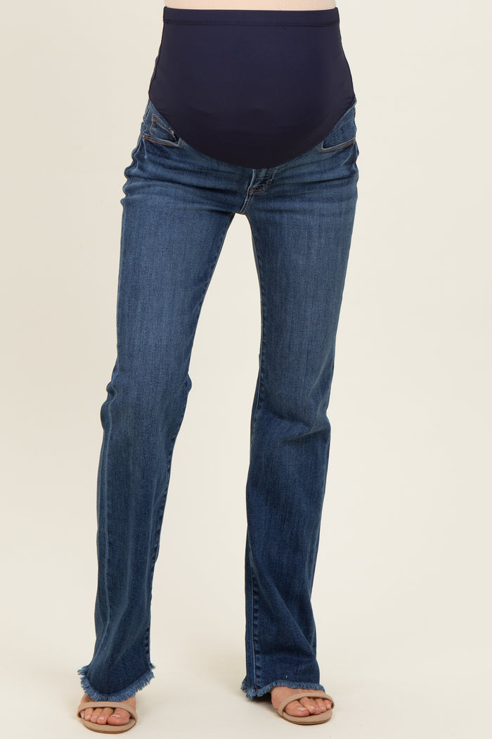 woman wearing dark blue maternity jeans with a stretchy waistband and frayed hem details