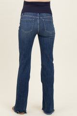 woman wearing dark blue maternity jeans with a stretchy waistband and frayed hem, showing the back view
