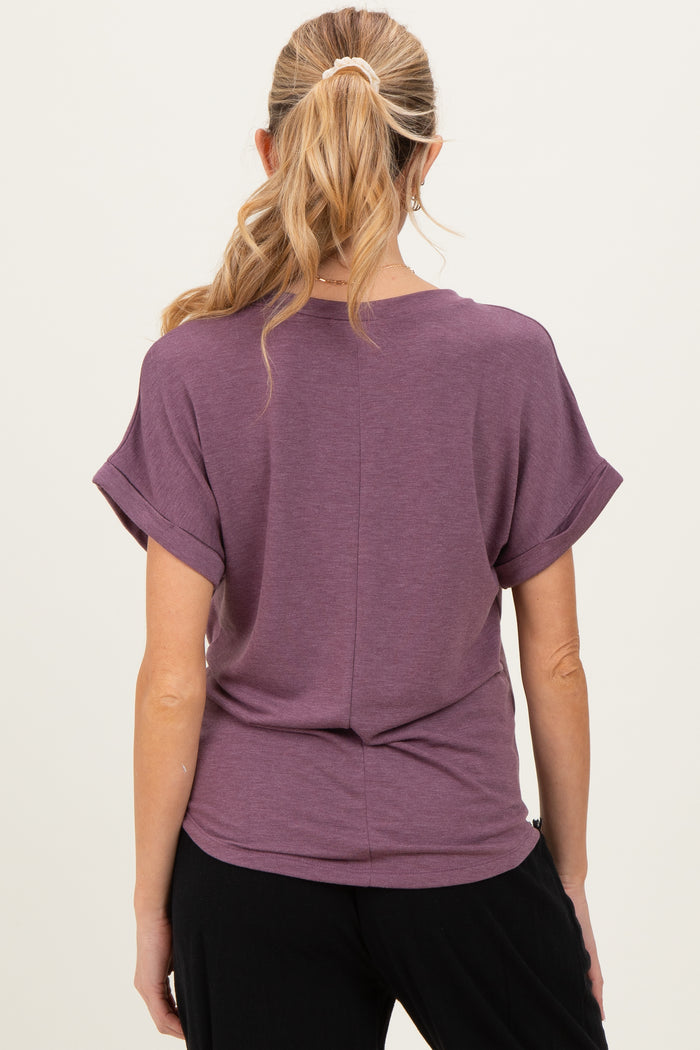 woman wearing a purple maternity top with rolled short sleeves and a relaxed fit from the back