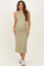 woman wearing a light olive green maternity sleeveless dress with a fitted silhouette and a visible baby bump