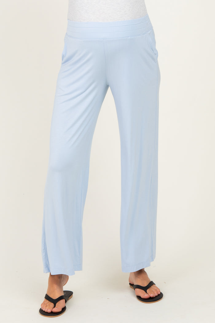 woman wearing light blue maternity wide-leg pants with side slits and a comfortable waistband