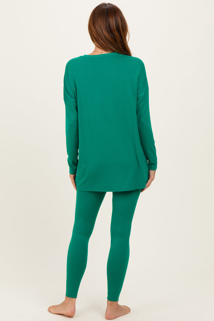 woman wearing a green long sleeve top and matching leggings, viewed from the back
