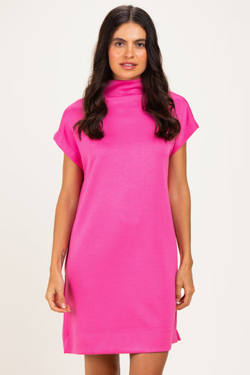 woman wearing a pink short sleeve dress with a high neckline and relaxed fit