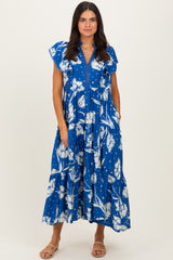 woman wearing a blue floral maxi dress with ruffle sleeves and a v-neckline