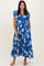 woman wearing a blue floral maxi dress with ruffle sleeves and a v-neckline