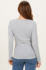 woman wearing a fitted grey long sleeve top, showing the back view with a scoop neckline and soft fabric