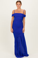 woman wearing a royal blue off-the-shoulder maxi dress with ruched detailing and a flowy bottom