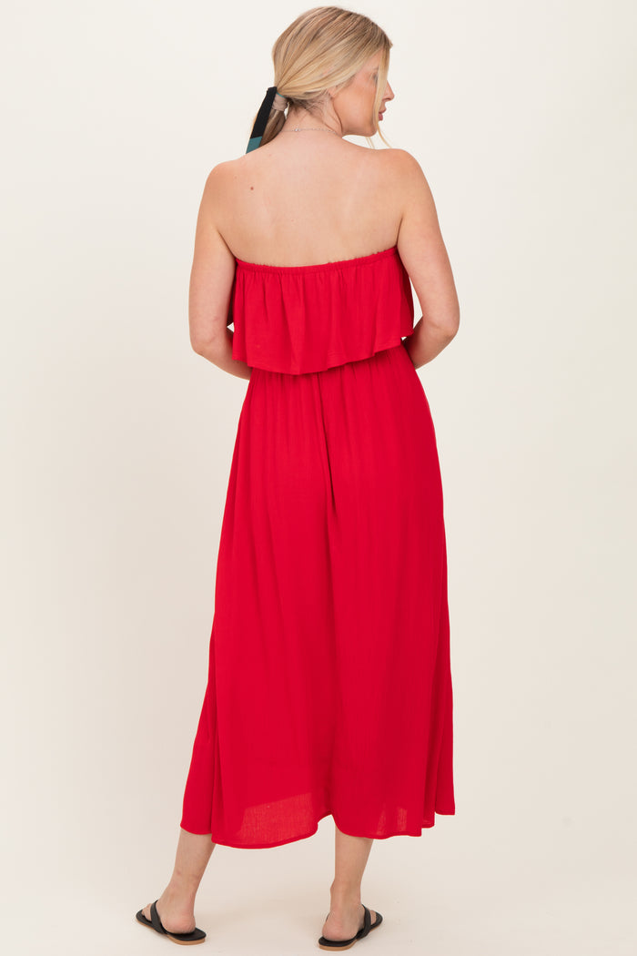 woman wearing a red strapless maxi dress with a ruffled top, showing the back view and styled with a ponytail
