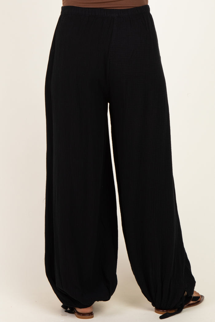woman wearing black maternity wide-leg pants with a comfortable elastic waistband and relaxed fit