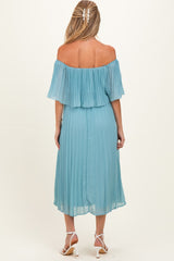 woman wearing a light blue off-the-shoulder pleated maternity dress with a flowy skirt